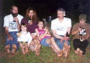 Barefoot hikers drinking root beer